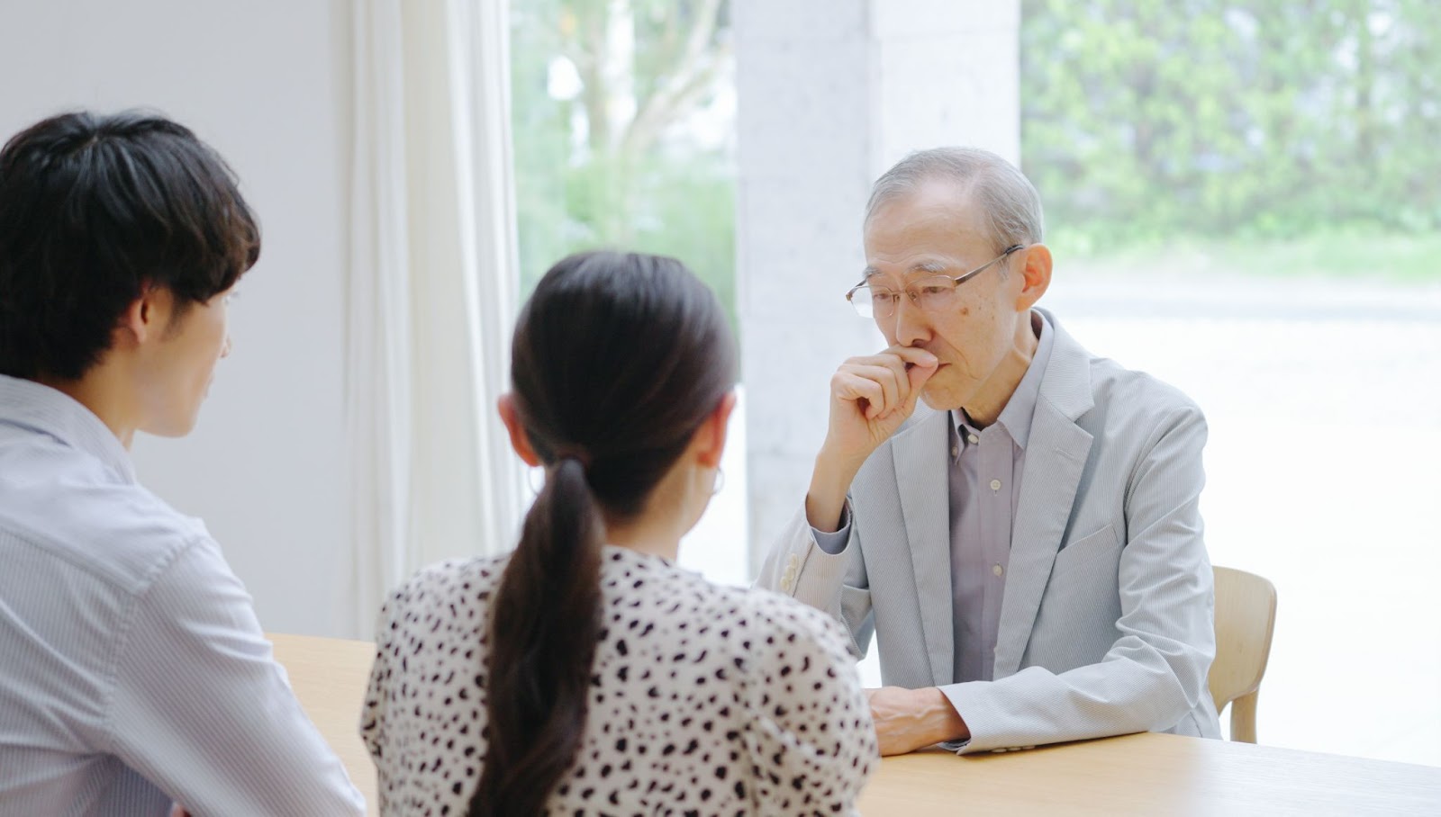 Senior man having an important discussion with his children.