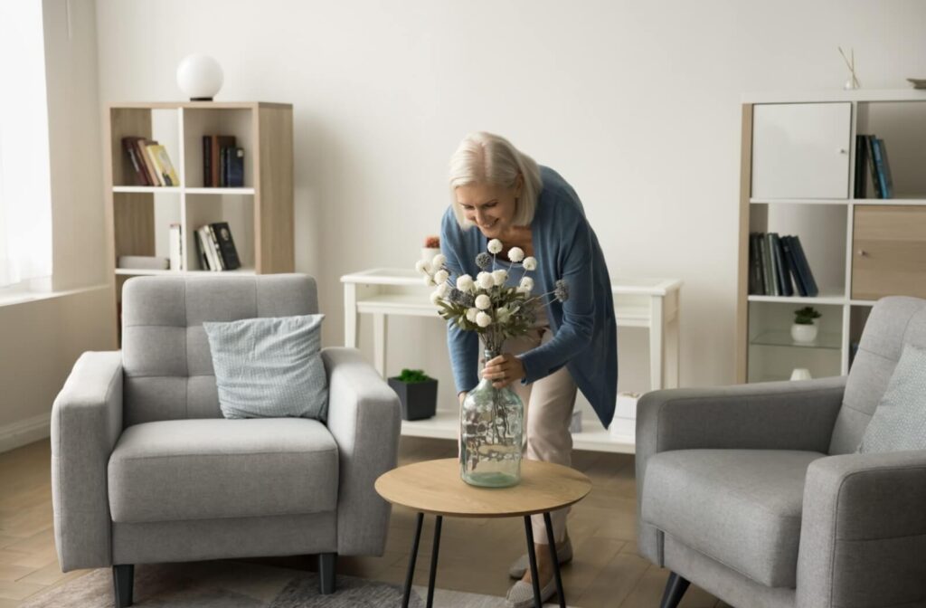 A senior resident changes the decor in their room, keeping things fresh and inviting.