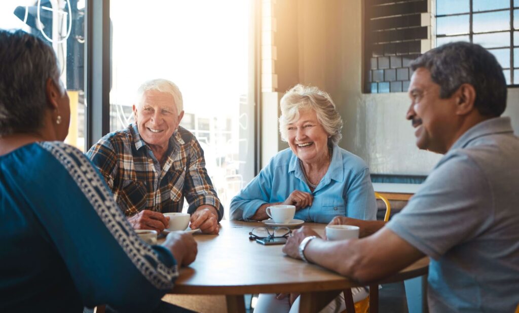 A group of seniors gather together in an assisted living community.