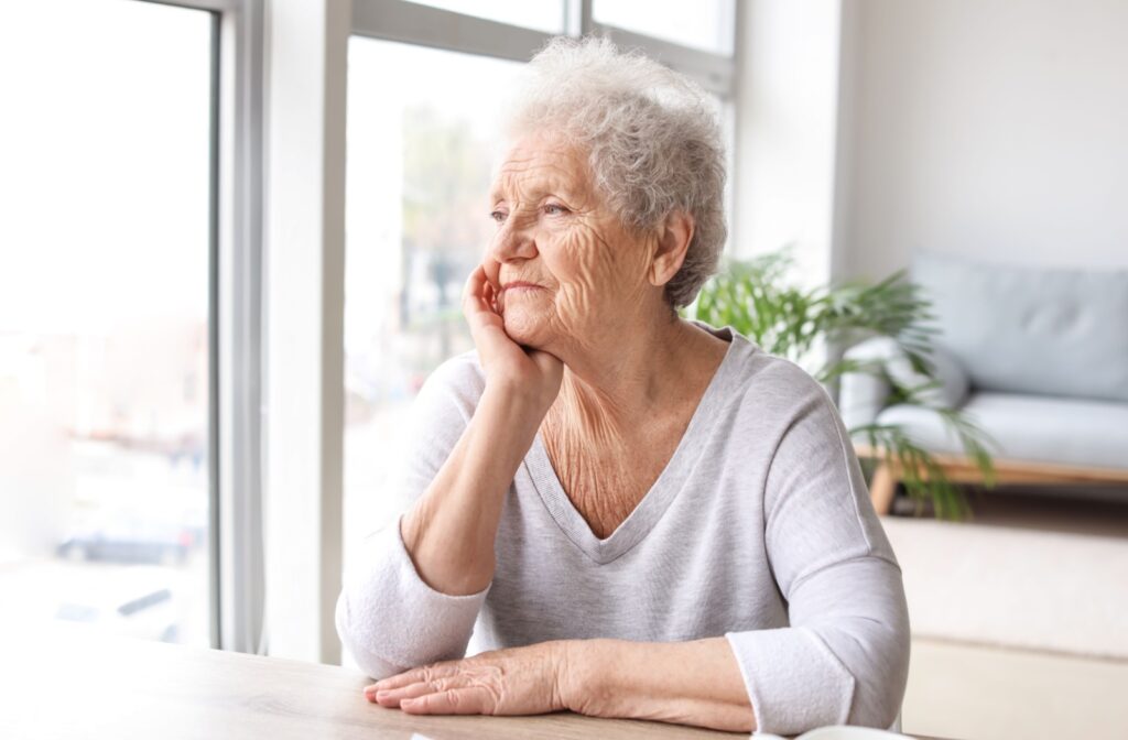 senior looking outside of the window in assisted living