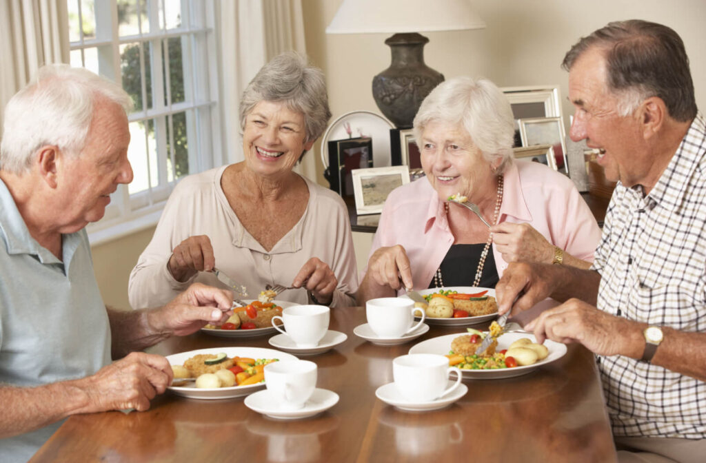 seniors enjoying a meal together in assisted living
